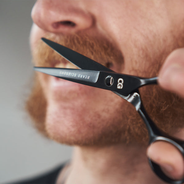 Man trimming his mustache