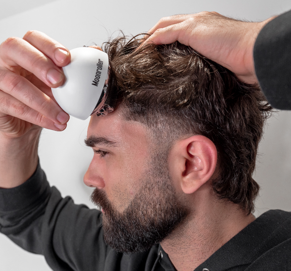 Young man using  beard oil from Copenhagen Grooming